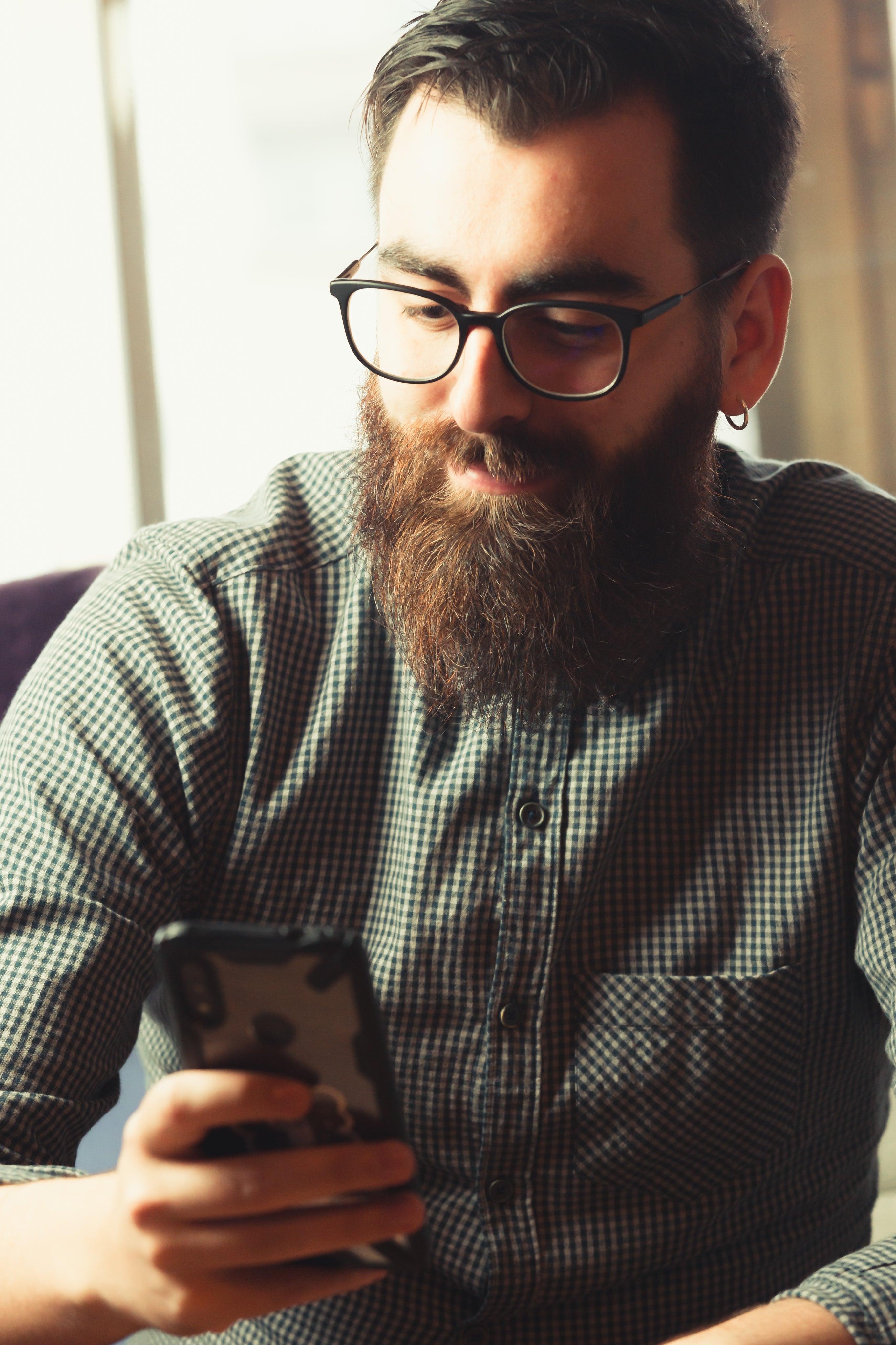 files/man-in-green-looks-at-his-cell-phone.jpg